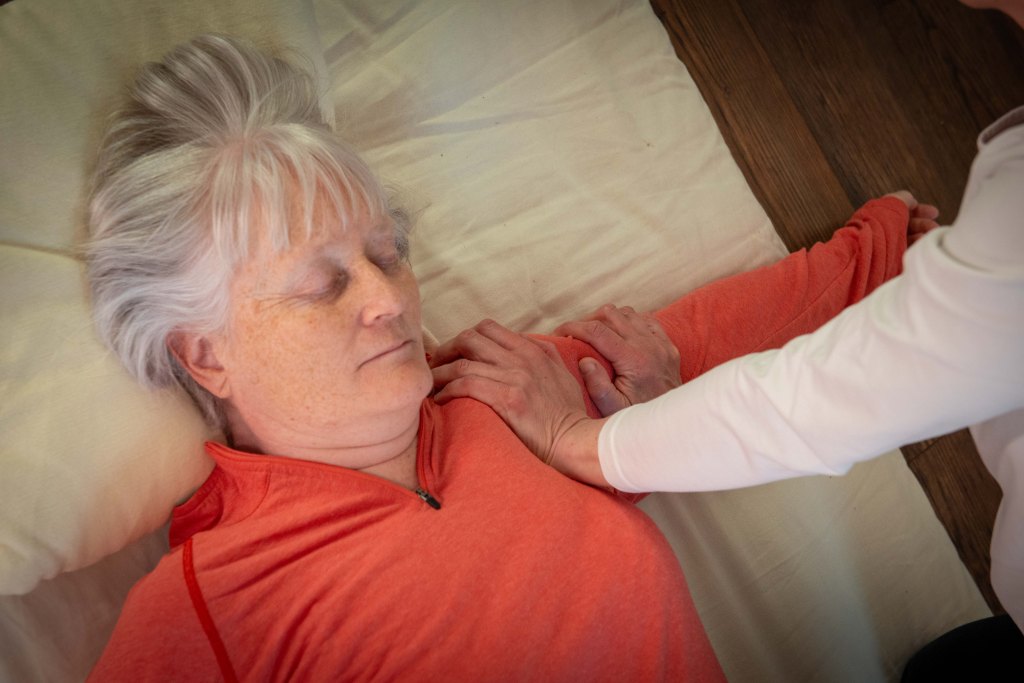 Close up of Shiatsu receiver, Liz's hands can be seen is working along the arm