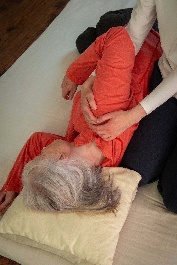 Receiving lying on their side, Liz's hands seen working the receiver's shoulder area